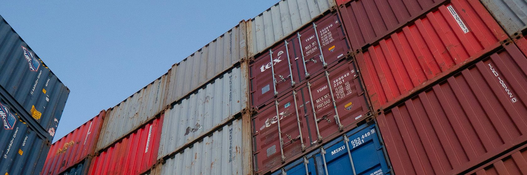 Containers i olika färger staplade på varandra