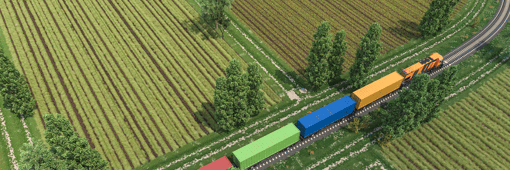 Godstransport på tåg i landskap med gröna odlingsfält